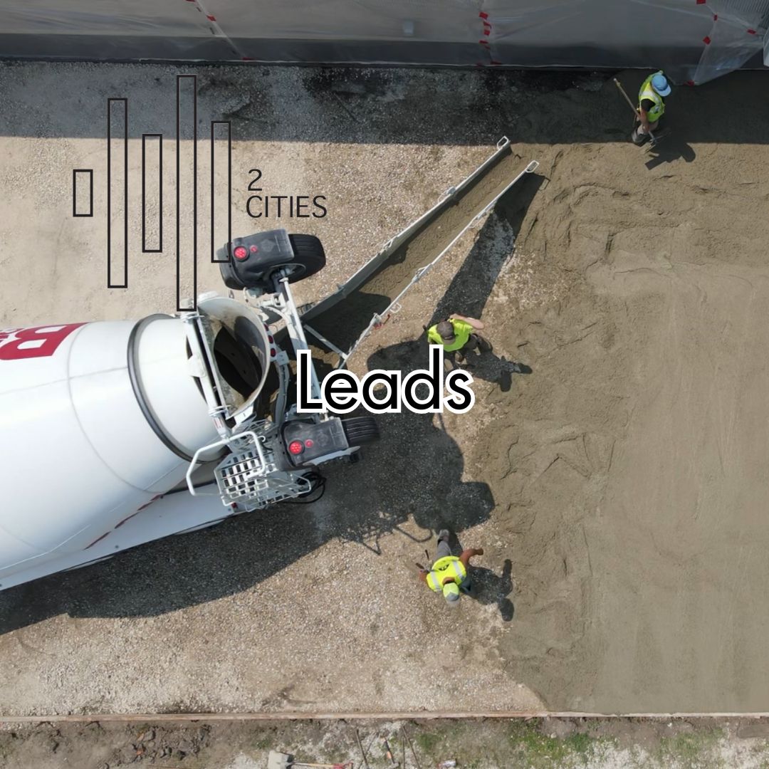 Aerial view of a concrete mixer and workers on a construction site with text overlay.